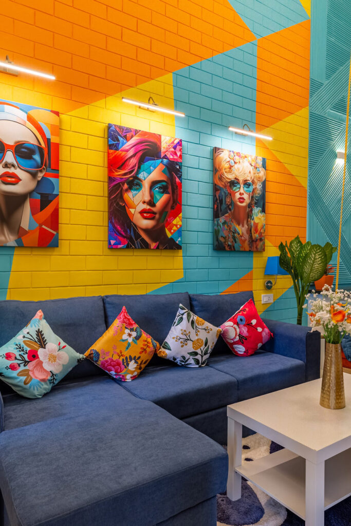 The living room at Tipsy, with its pop-art mural and blue sectional